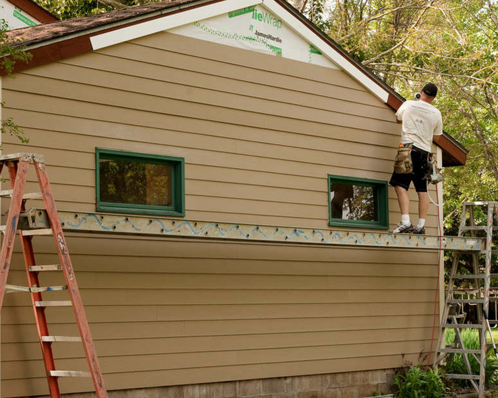 contractor installing siding at house exteriors poland oh